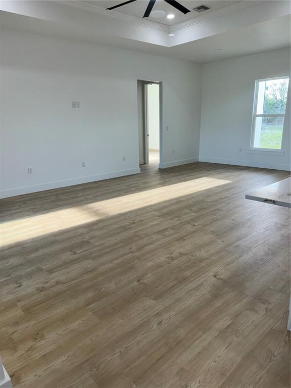 1721 McClellan Road Frostproof, FL 33843 - Photo 14 of 41 a view of an empty room with wooden floor and a window