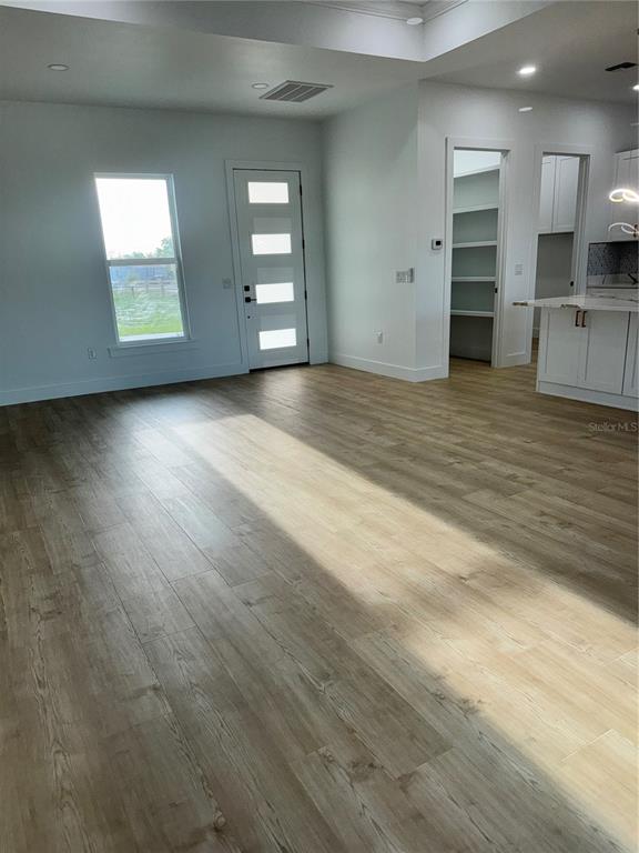 1721 McClellan Road Frostproof, FL 33843 - Photo 19 of 41 an empty room with wooden floor and windows