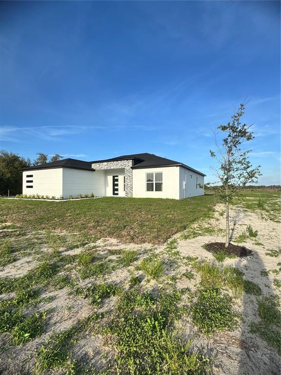 1721 McClellan Road Frostproof, FL 33843 - Photo 2 of 41 a view of a house with a yard