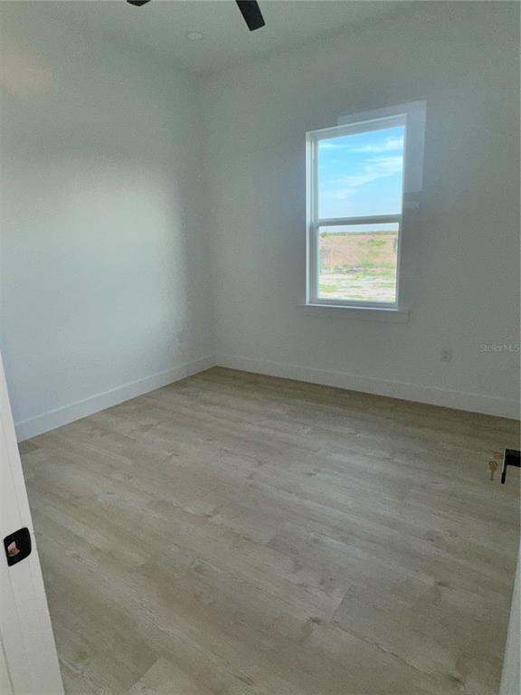 1721 McClellan Road Frostproof, FL 33843 - Photo 23 of 41 an empty room with a window