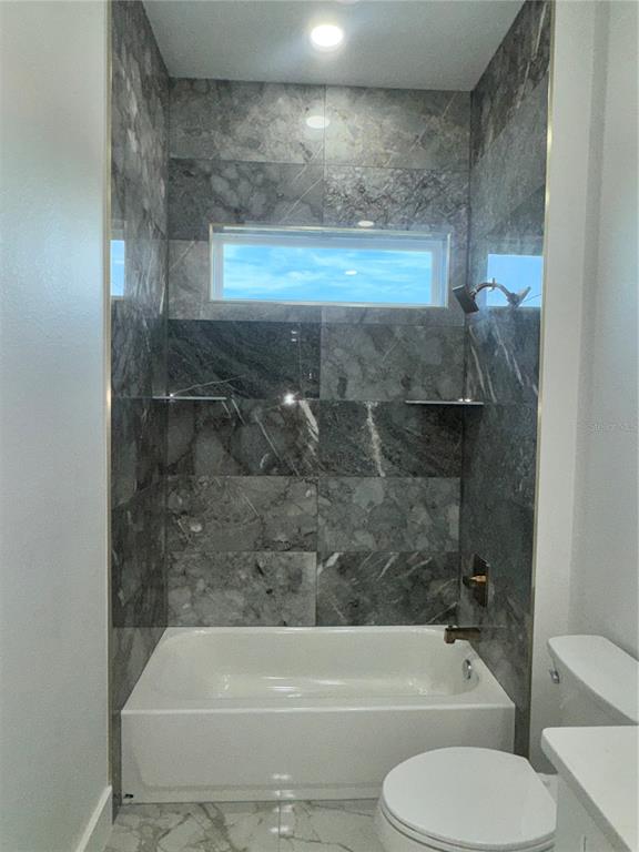 1721 McClellan Road Frostproof, FL 33843 - Photo 26 of 41 a bathroom with a toilet and bathtub
