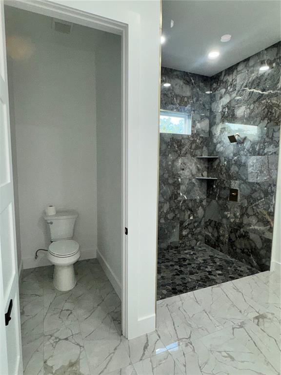 1721 McClellan Road Frostproof, FL 33843 - Photo 36 of 41 a bathroom with a toilet and a shower