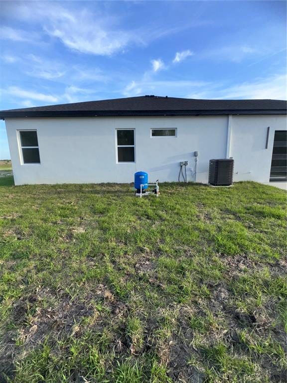 1721 McClellan Road Frostproof, FL 33843 - Photo 40 of 41 a backyard of a house with lots of green space