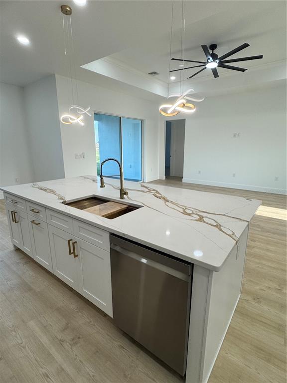 1721 McClellan Road Frostproof, FL 33843 - Photo 6 of 41 a kitchen with a sink dishwasher a stove and a refrigerator with wooden floor