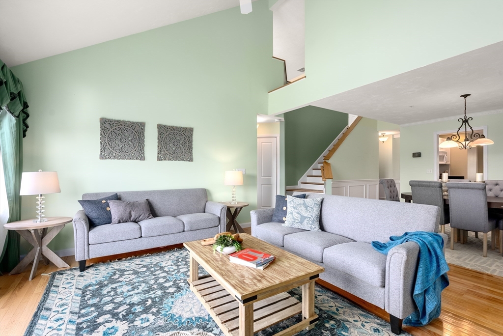 5 Strawberry Lane, Unit E Hudson, MA 01749 - Photo 14 of 42 a living room with furniture and a wooden floor