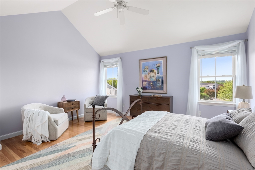 5 Strawberry Lane, Unit E Hudson, MA 01749 - Photo 18 of 42 a bedroom with a bed and a chandelier