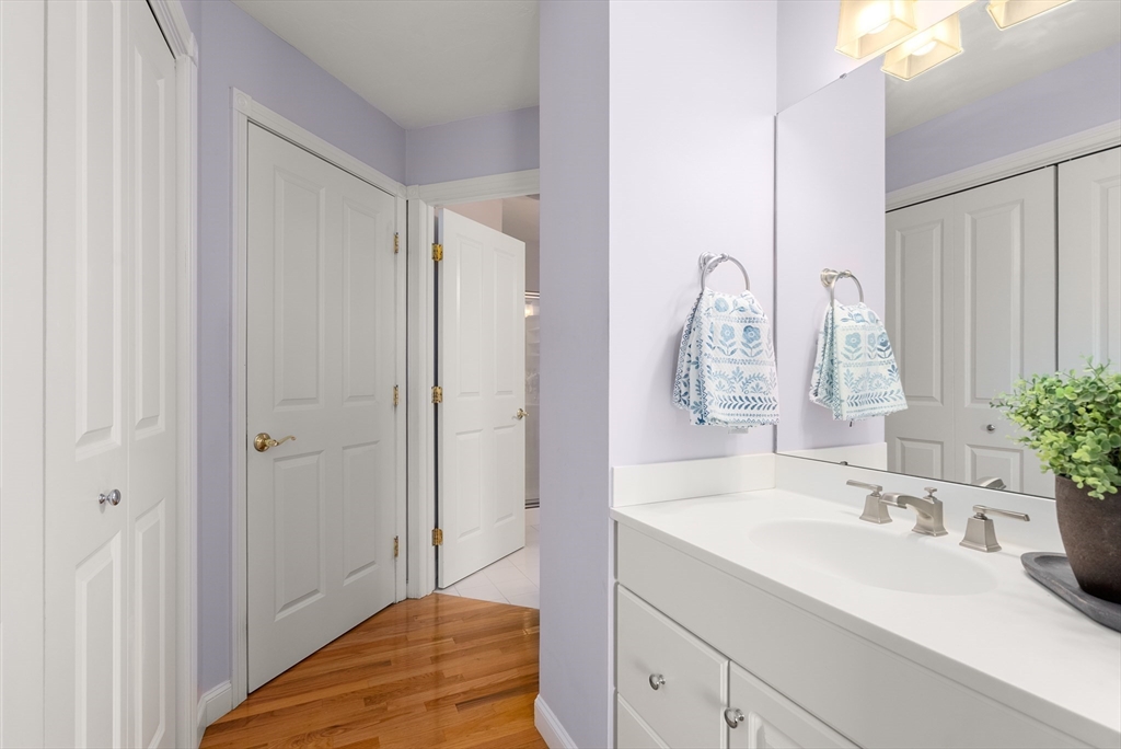 5 Strawberry Lane, Unit E Hudson, MA 01749 - Photo 20 of 42 a bathroom with a sink and a mirror