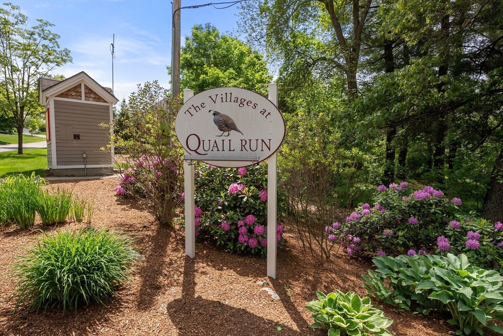5 Strawberry Lane, Unit E Hudson, MA 01749 - Photo 2 of 42 a view of a wooden house with a flower garden