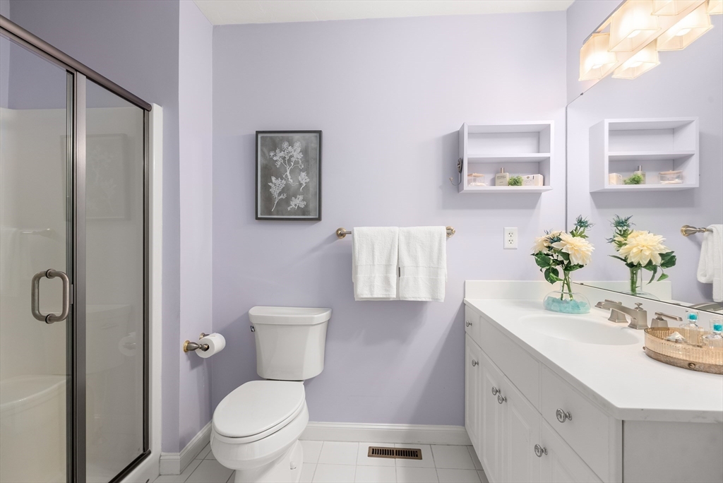 5 Strawberry Lane, Unit E Hudson, MA 01749 - Photo 21 of 42 a bathroom with a sink a toilet and shower