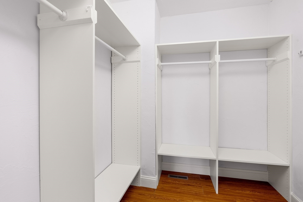 5 Strawberry Lane, Unit E Hudson, MA 01749 - Photo 22 of 42 a room with walk in closet and wooden floor