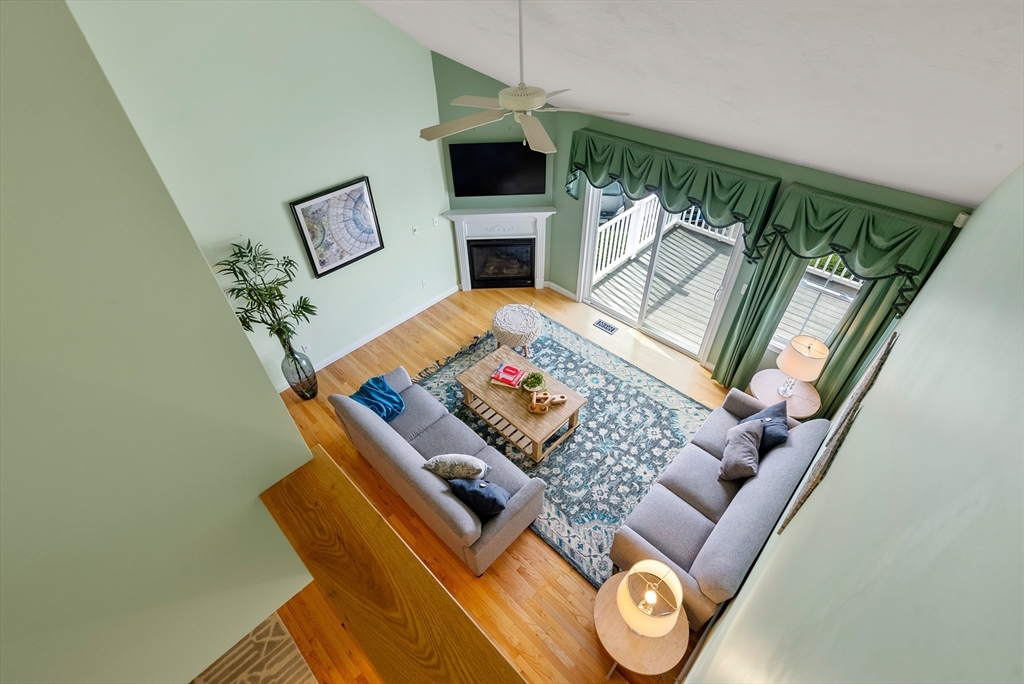 5 Strawberry Lane, Unit E Hudson, MA 01749 - Photo 25 of 42 a living room with furniture and a fireplace
