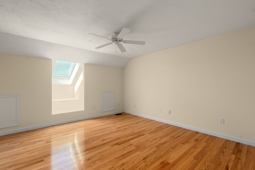 5 Strawberry Lane, Unit E Hudson, MA 01749 - Photo 27 of 42 a view of empty room with wooden floor and fan