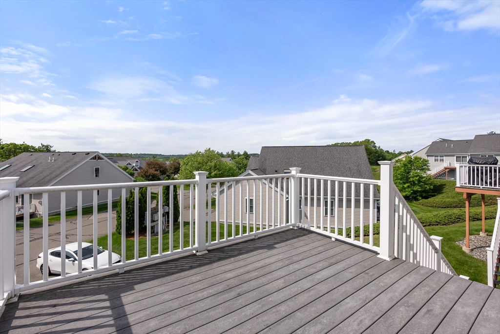5 Strawberry Lane, Unit E Hudson, MA 01749 - Photo 30 of 42 a view of balcony with wooden floor
