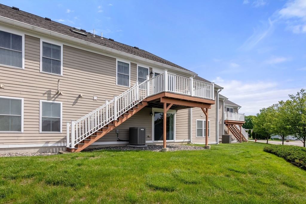 5 Strawberry Lane, Unit E Hudson, MA 01749 - Photo 35 of 42 a view of a house with backyard and garden