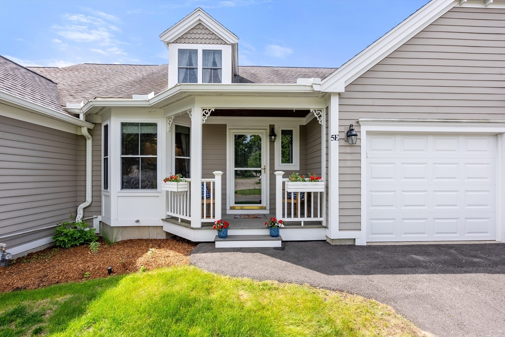 5 Strawberry Lane, Unit E Hudson, MA 01749 - Photo 41 of 42 a front view of a house with a garage