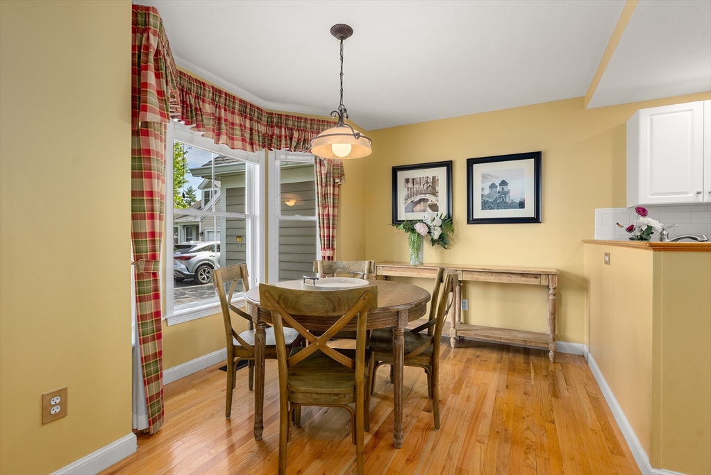 5 Strawberry Lane, Unit E Hudson, MA 01749 - Photo 7 of 42 a view of a dining room with furniture and wooden floor