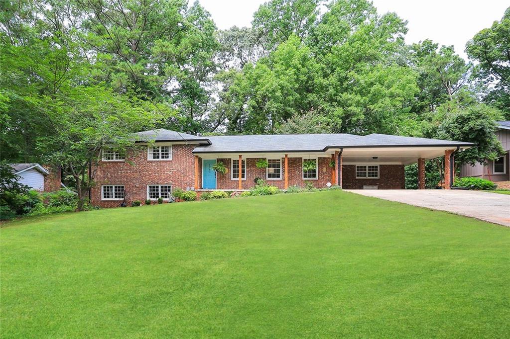 a front view of house with yard and green space