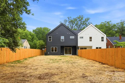 a view of a house with wooden fence