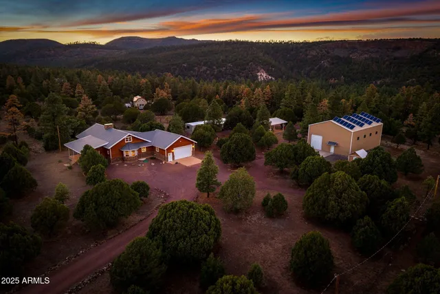 a view of a dining room with furniture a chandelier and wooden floor