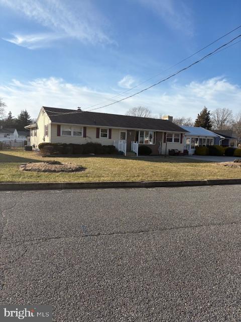 a view of a big house with a big yard and large trees