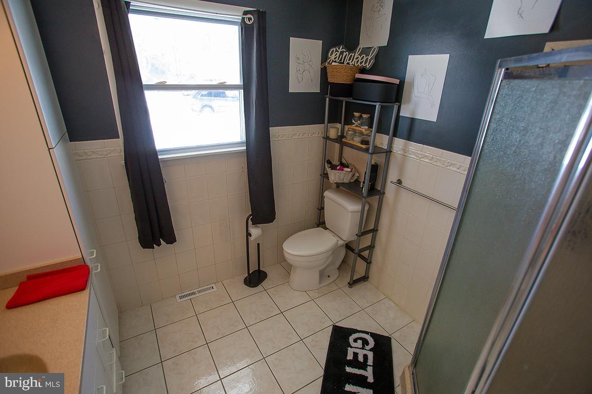 1232 Harding Road Vineland, NJ 08361 - Photo 2 of 29 a bathroom with a sink toilet and mirror