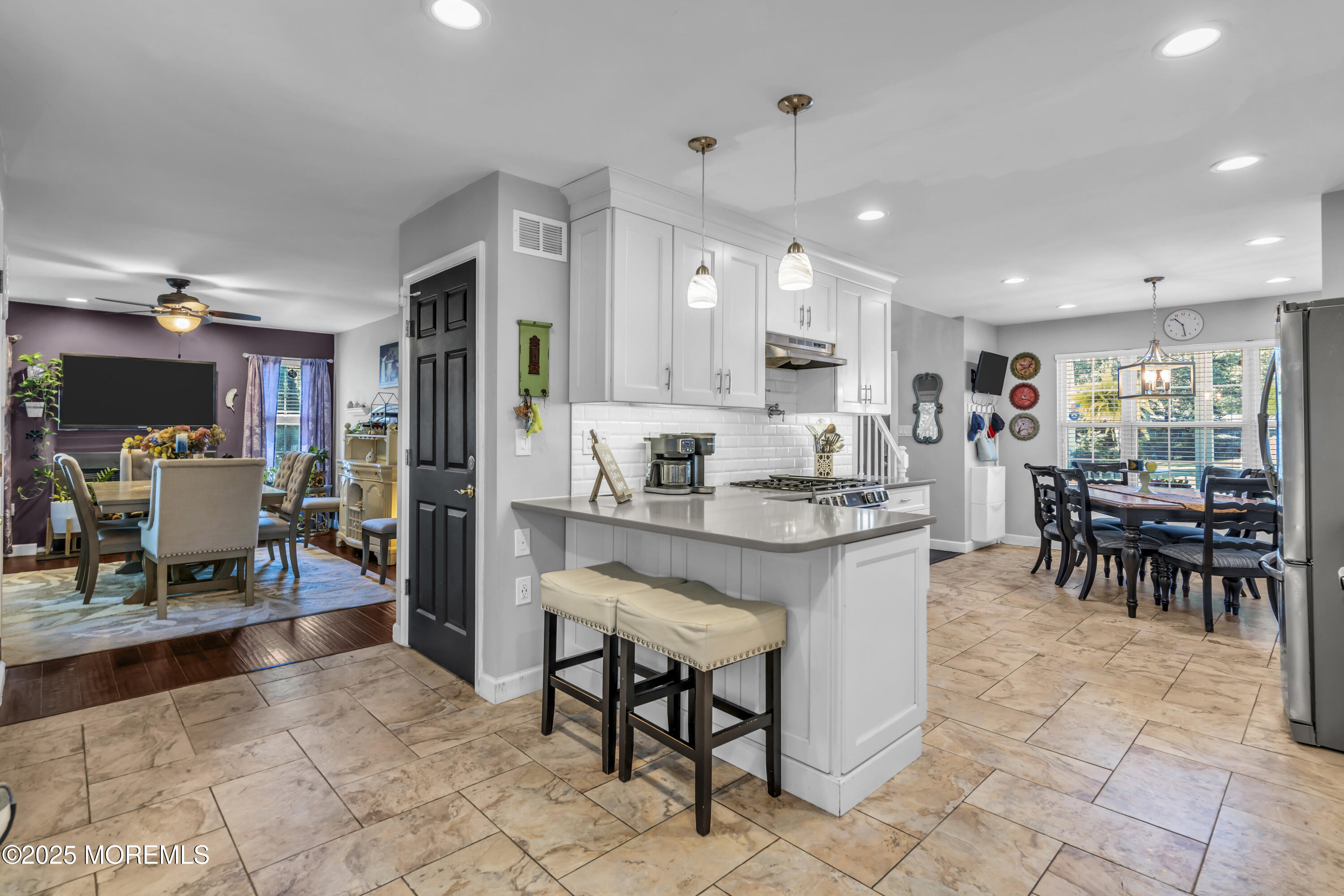 1 Sun Hollow Road Howell, NJ 07731 - Photo 11 of 47 a kitchen with stainless steel appliances kitchen island granite countertop a table chairs and a sink