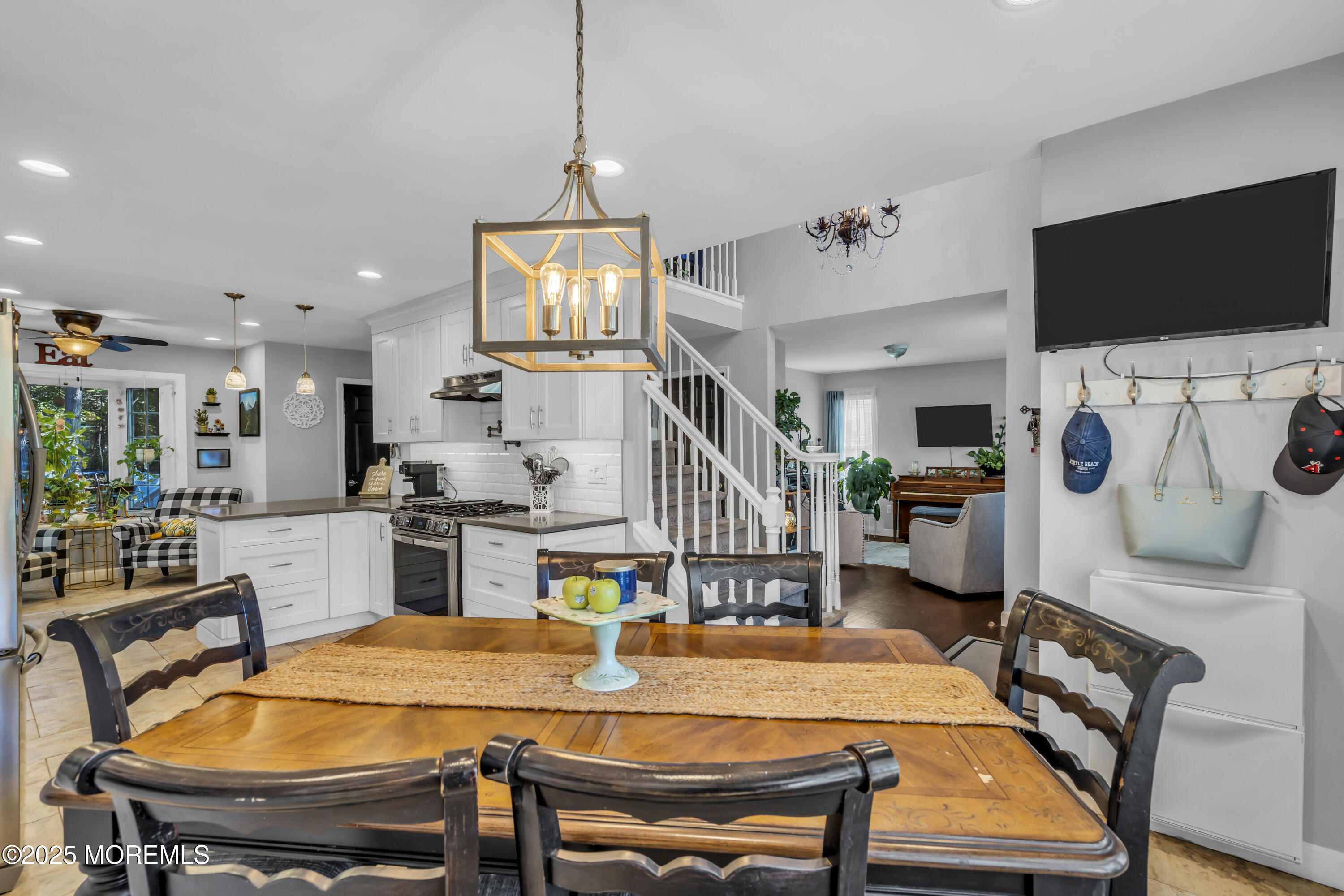 1 Sun Hollow Road Howell, NJ 07731 - Photo 14 of 47 a kitchen with stainless steel appliances kitchen island granite countertop a table chairs and a refrigerator