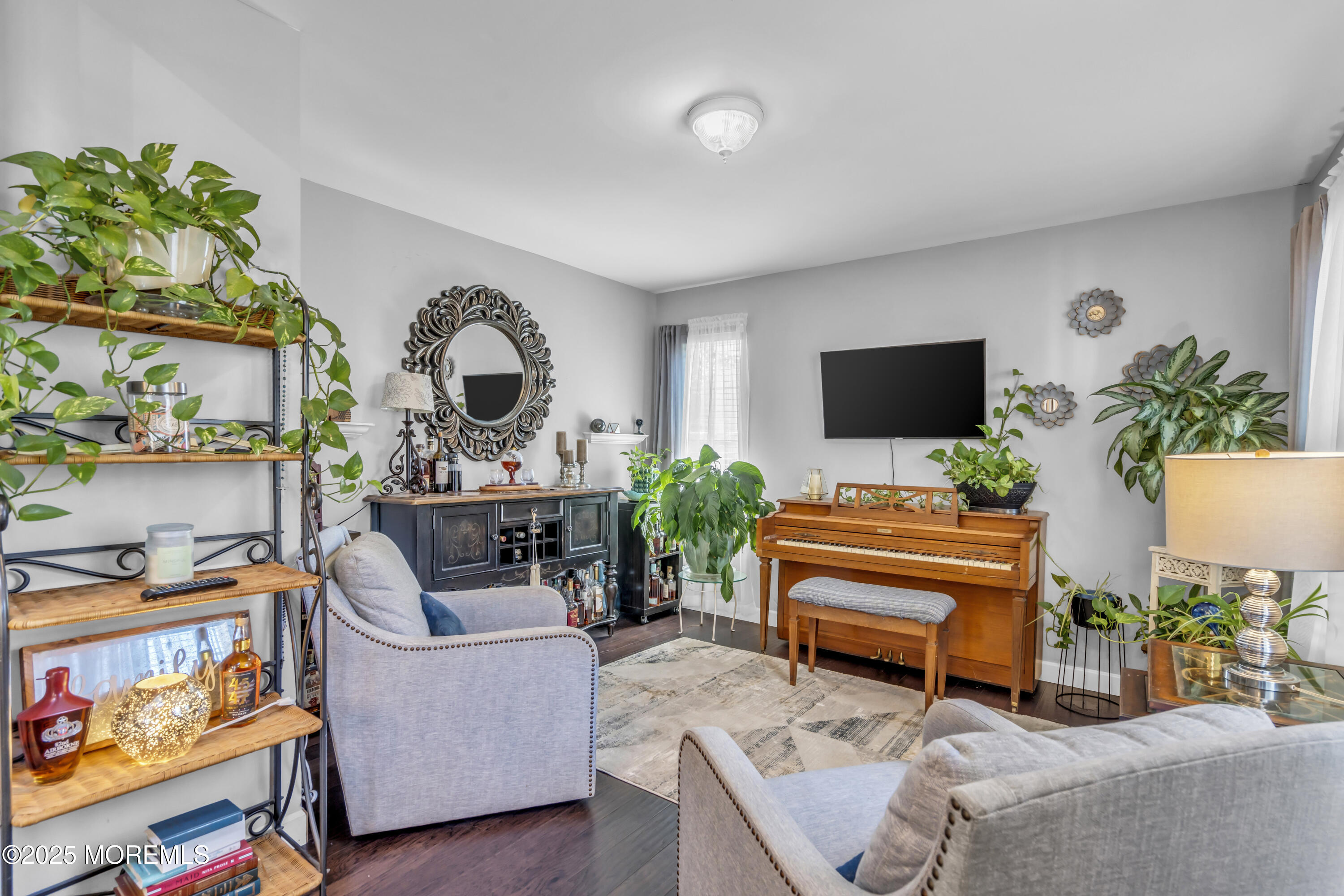 1 Sun Hollow Road Howell, NJ 07731 - Photo 19 of 47 a living room with furniture and a flat screen tv with wooden floor