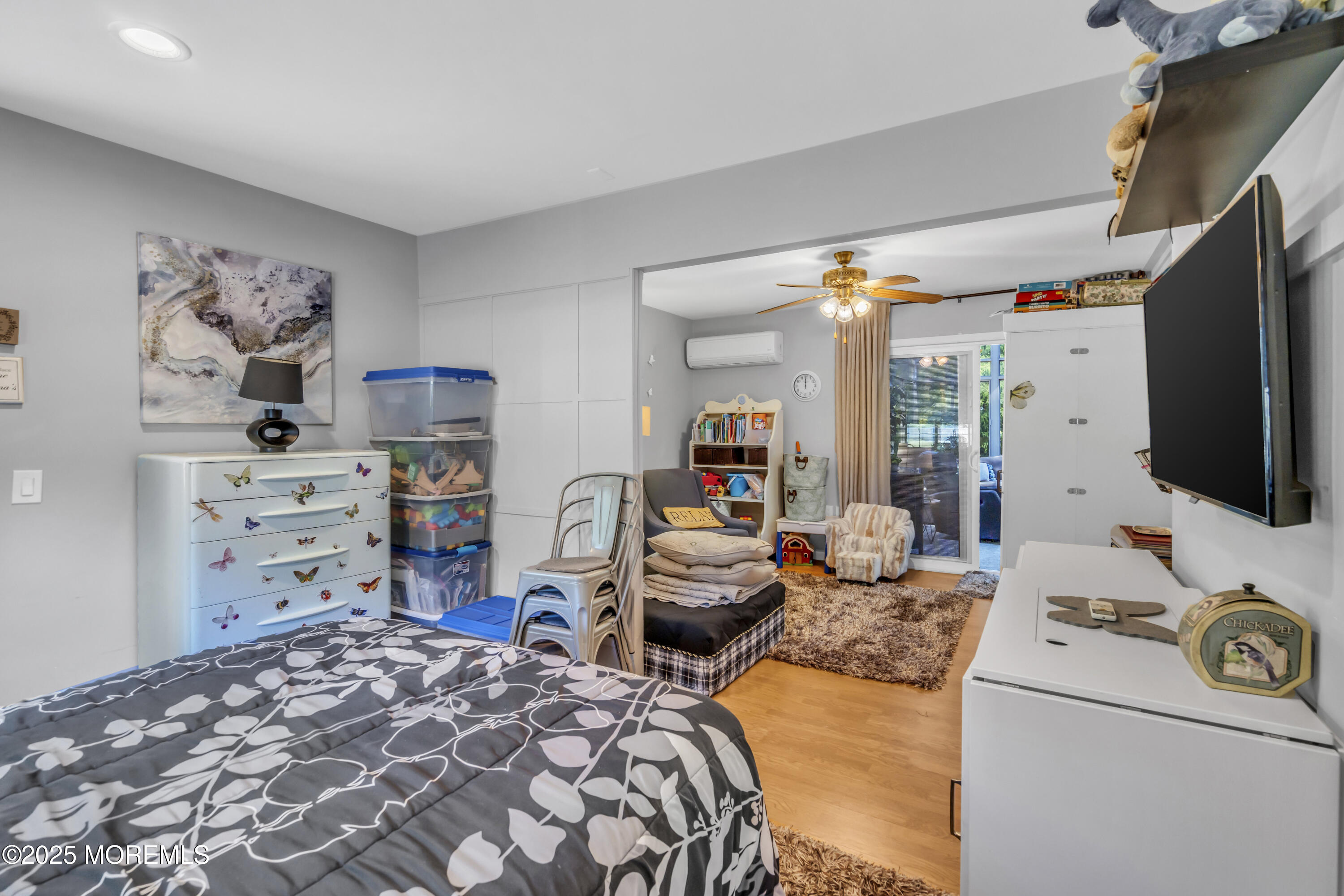 1 Sun Hollow Road Howell, NJ 07731 - Photo 28 of 47 a bedroom with furniture a flat screen tv and a refrigerator