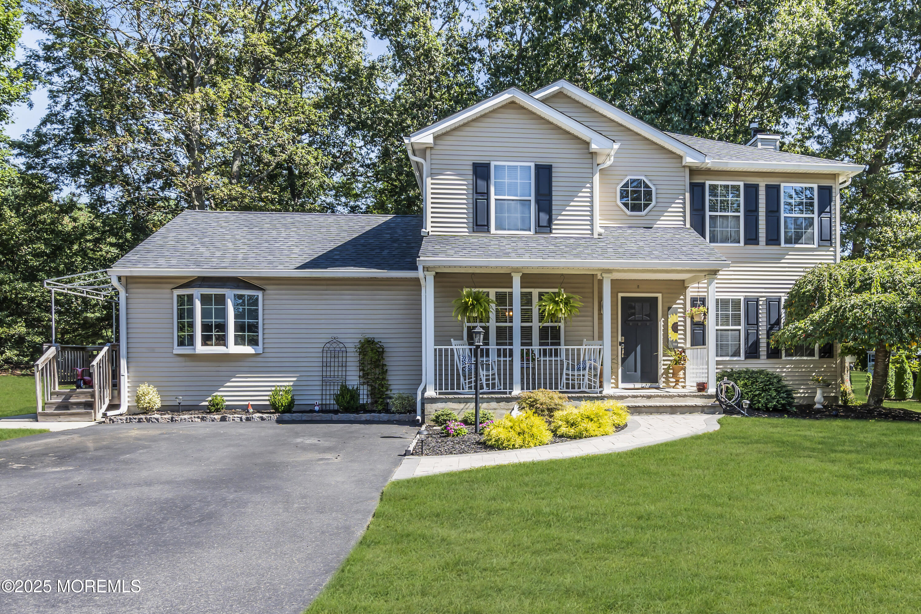 1 Sun Hollow Road Howell, NJ 07731 - Photo 3 of 47 a view of a white house with a big yard and large trees