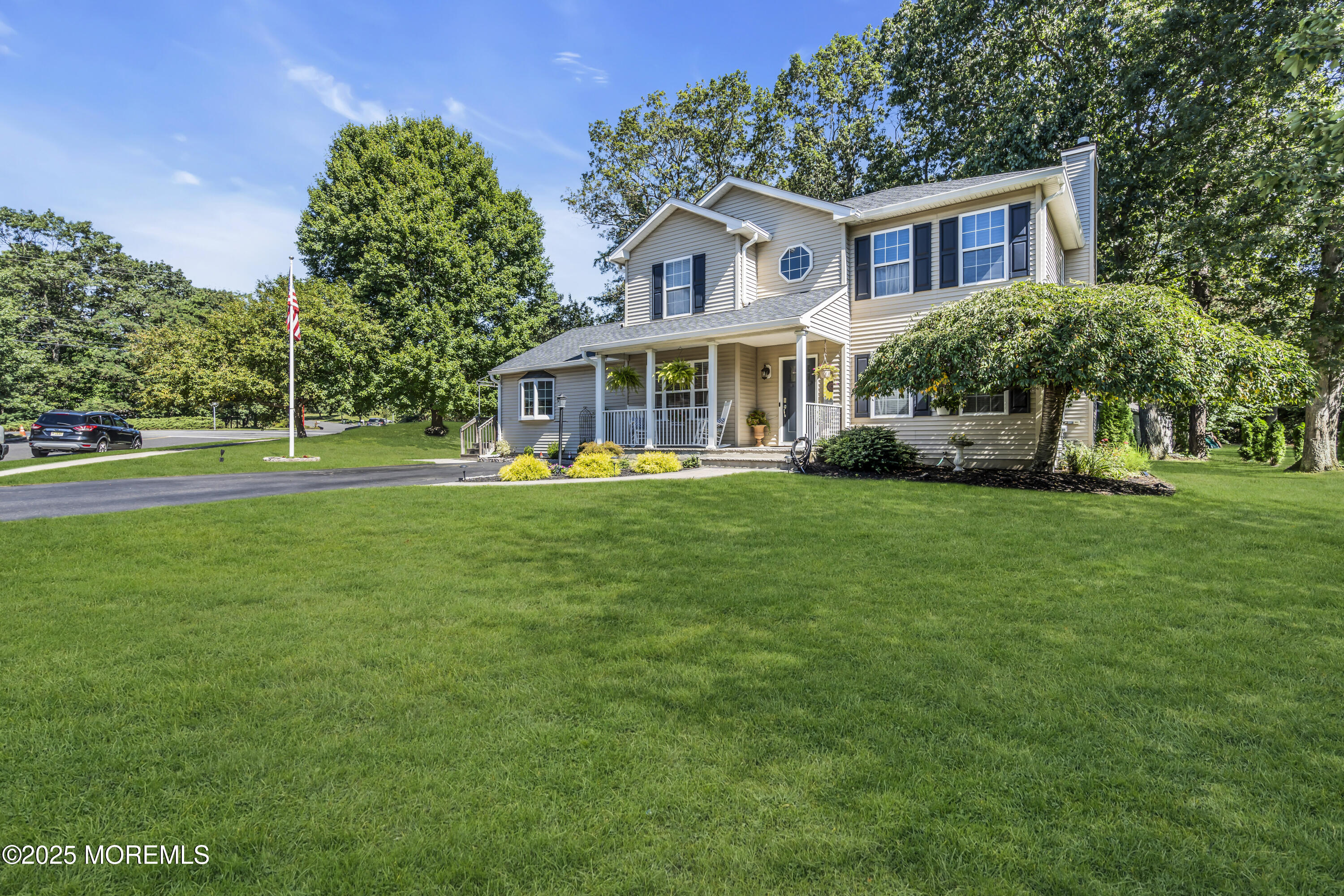 1 Sun Hollow Road Howell, NJ 07731 - Photo 8 of 47 a front view of a house with garden and trees