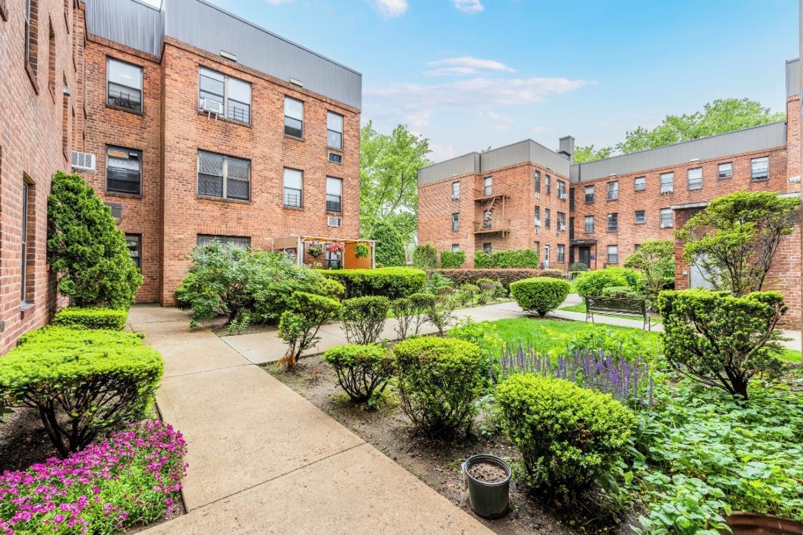 a view of a building and garden with flowers