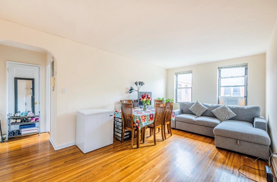 215-43 48th Avenue, Unit 3A Queens, NY 11364 - Photo 3 of 16 a living room with furniture and wooden floor