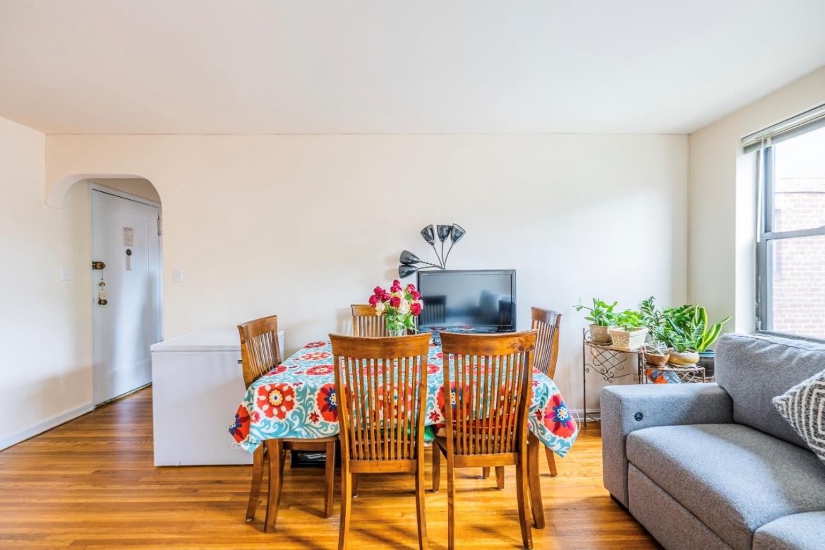 215-43 48th Avenue, Unit 3A Queens, NY 11364 - Photo 4 of 16 a living room with furniture and wooden floor