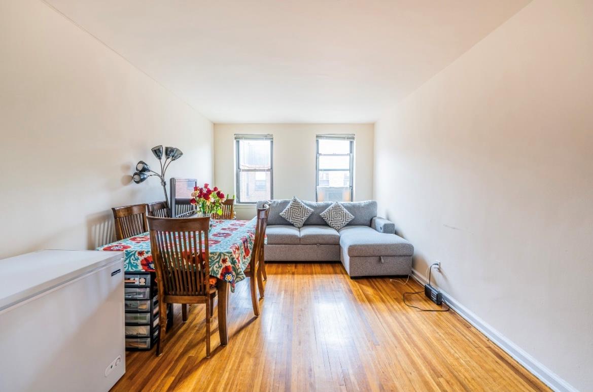 215-43 48th Avenue, Unit 3A Queens, NY 11364 - Photo 6 of 16 a living room with furniture and wooden floor