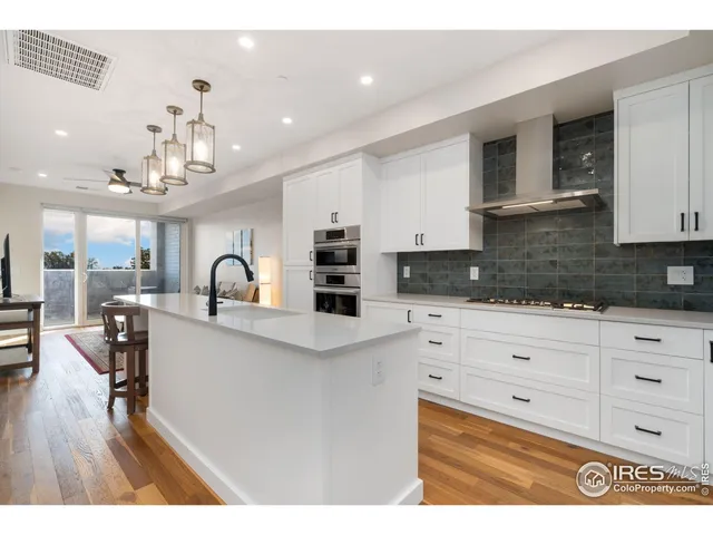 a kitchen with a refrigerator and a sink