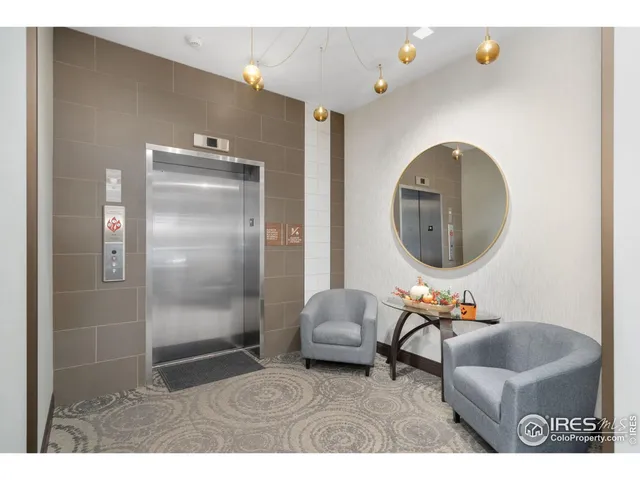 a living room with furniture and a mirror