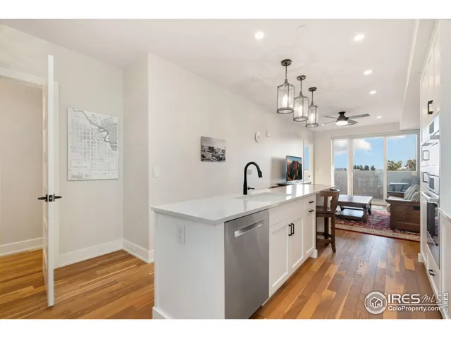 a open kitchen with sink cabinets and wooden floor