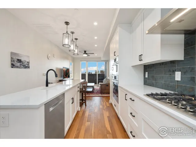 a large kitchen with kitchen island a sink stainless steel appliances and cabinets