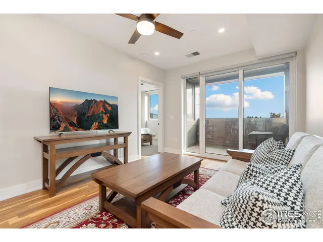 a living room with furniture a rug and a flat screen tv
