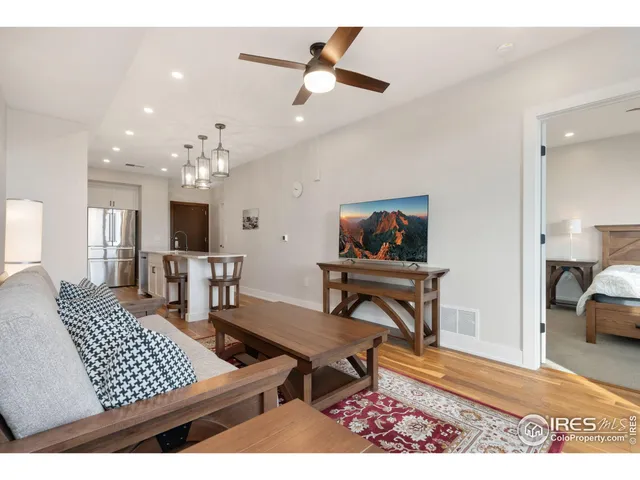 a living room with furniture a rug and a chandelier