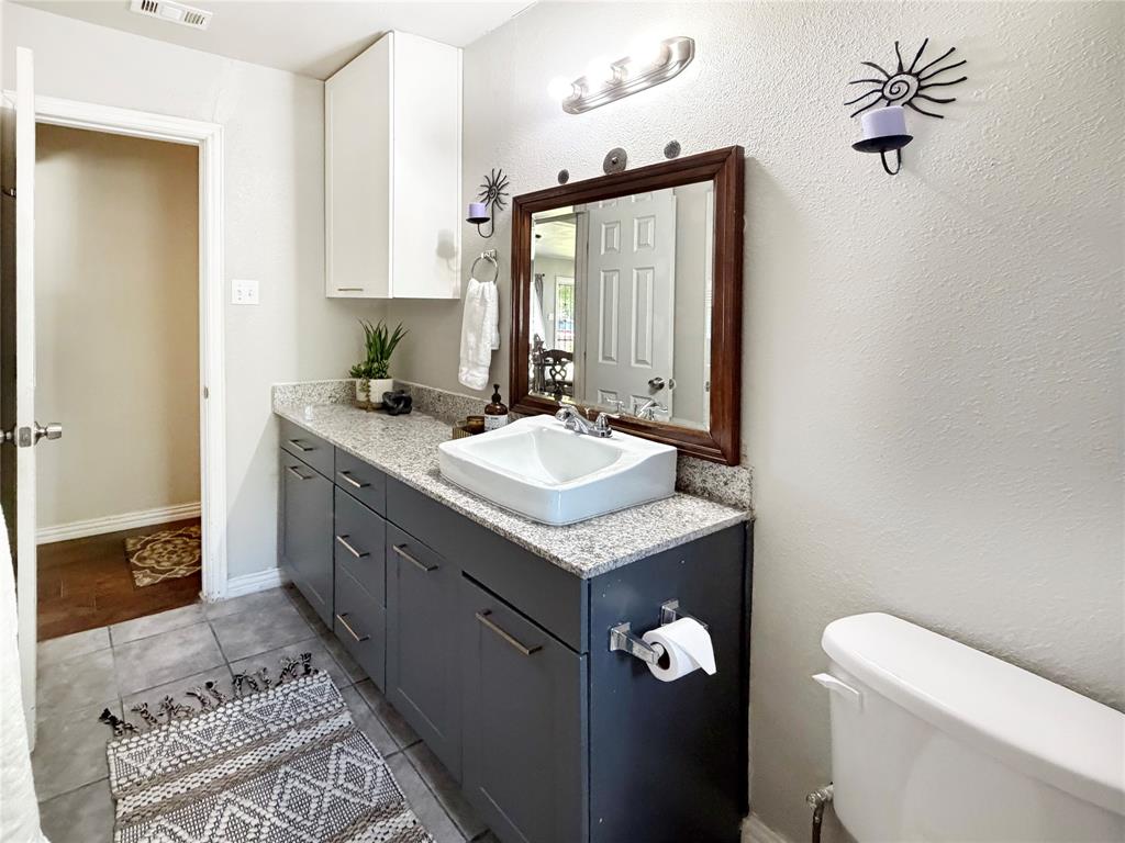 2243 Inca Drive Dallas, TX 75216 - Photo 18 of 24 Bathroom 2 features updated cabinetry for ample storage.