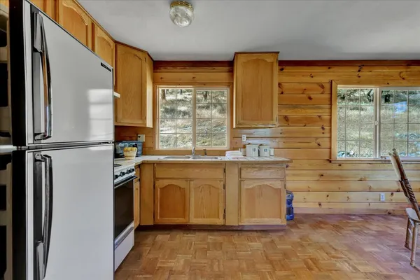 a living room with furniture and a dining table