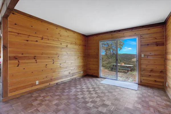 an aerial view of residential houses with outdoor space and trees