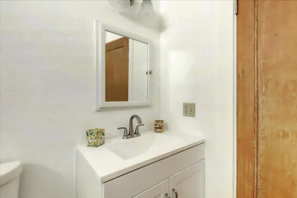 an aerial view of a houses with a lush green hillside