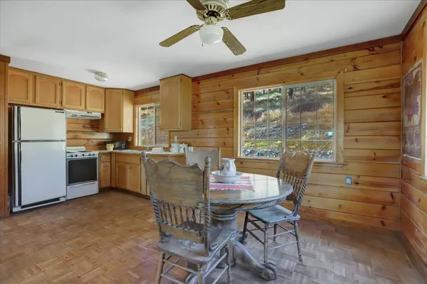 a kitchen with stainless steel appliances granite countertop a sink and a white cabinets