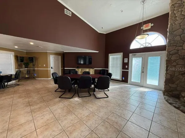 a living room with furniture a dining table and a potted plant