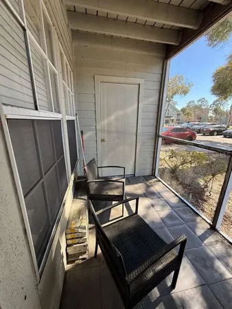 a view of a balcony with wooden floor and iron stairs