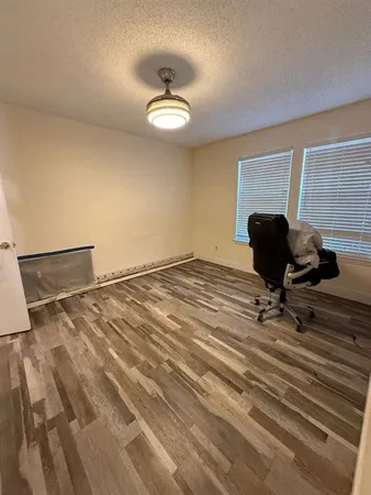 a view of a room with wooden floor and fan