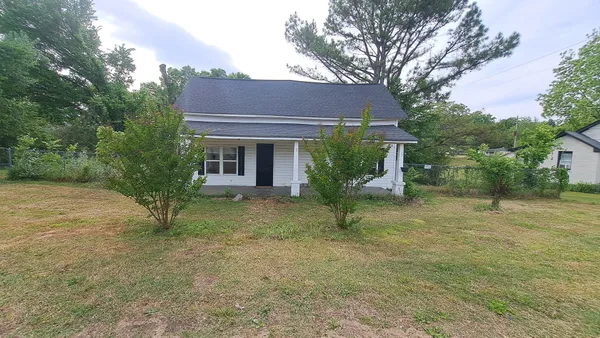 a view of a house with a small yard and plants